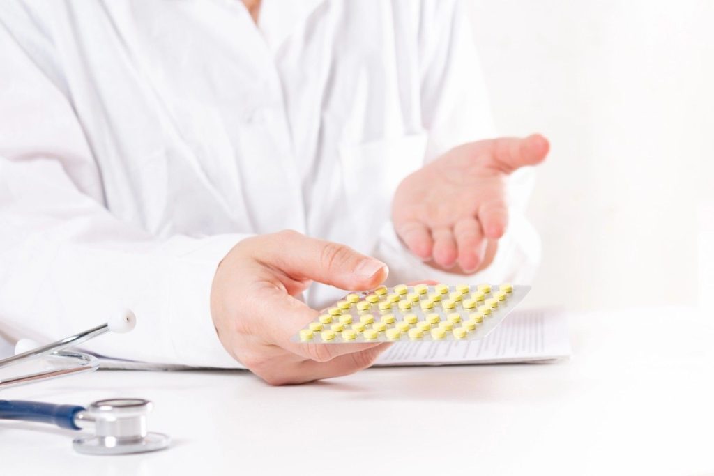 Doctor handing over prescription medication at an urgent care clinic with Ambetter coverage in Gulfton.