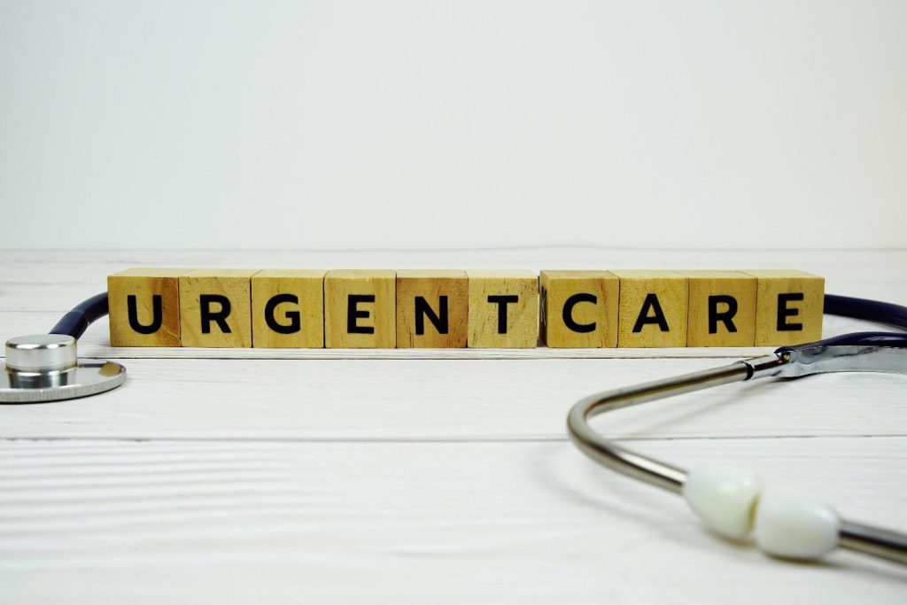 “URGENT CARE" spelled out in wooden blocks with a stethoscope, representing a walk-in clinic that accepts Ambetter insurance in Gulfton