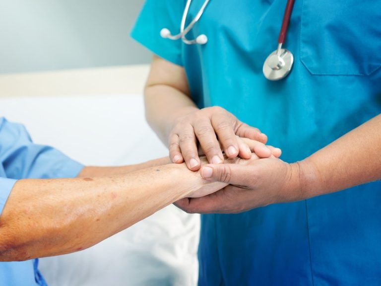 Healthcare provider offering comforting hand hold to patient at urgent care that accepts Ambetter Houston