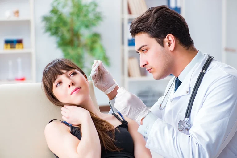 A nurse examines a patient's ear at an Ambetter covered medical clinic.