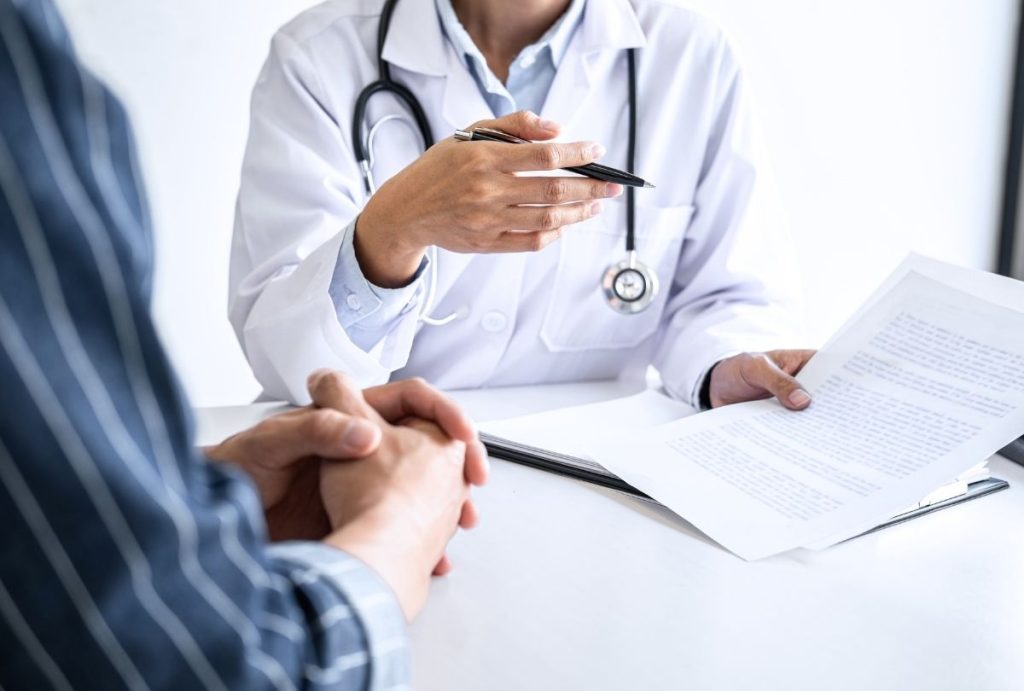 Doctor reviewing test results during an Annual Physical Exam, explaining care plan and preventive screening options to patient