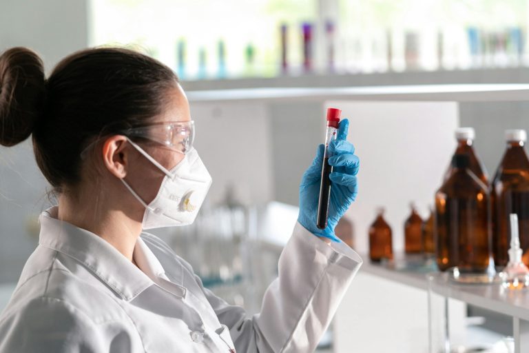 Professional lab technician analyzing a blood sample at a top-rated urgent care clinic Houston medical facility.