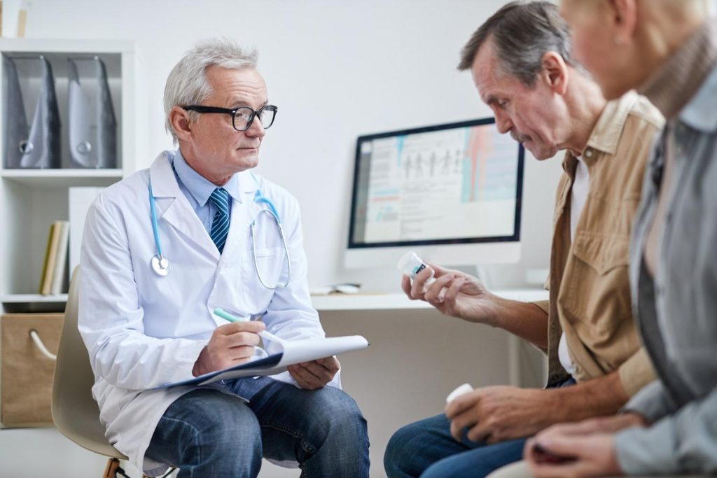 Medical provider discussing medication with seniors at an Ambetter health urgent care clinic Houston office.