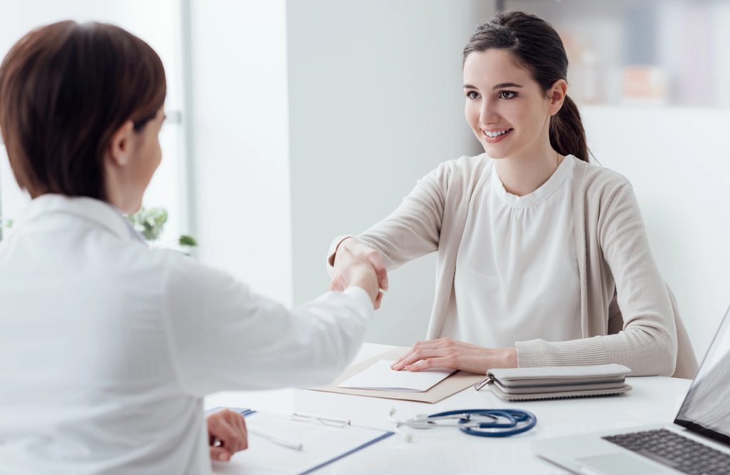 A doctor and patient shake hands after a successful consultation at an Ambetter approved urgent care houston clinic.