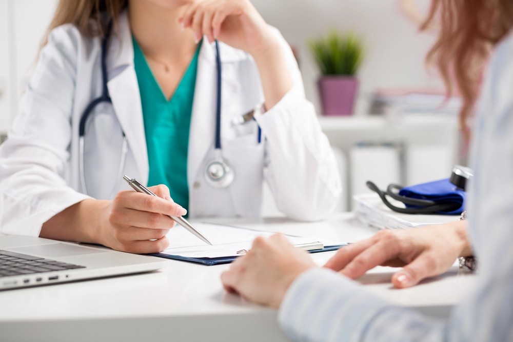 A doctor reviews medical documents with a patient at family clinics that accept Ambetter in Houston, Texas.