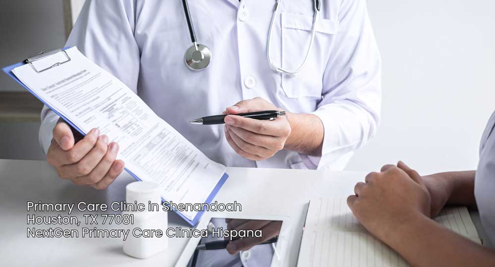 Physician explaining a health report clipboard to a patient inside a modern primary care clinic Houston facility.